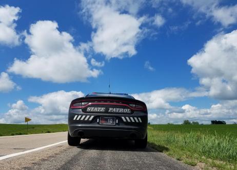 back of state patrol car and blue skies