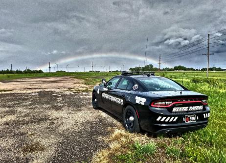 patrol vehicle with rainbow in distance