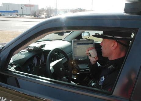 officer in patrol car talking on radio