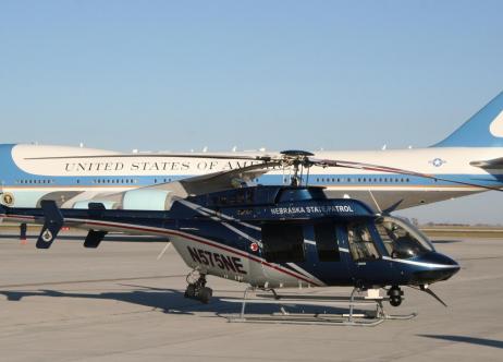 nebraska state patrol helicopter next to united states government airplane